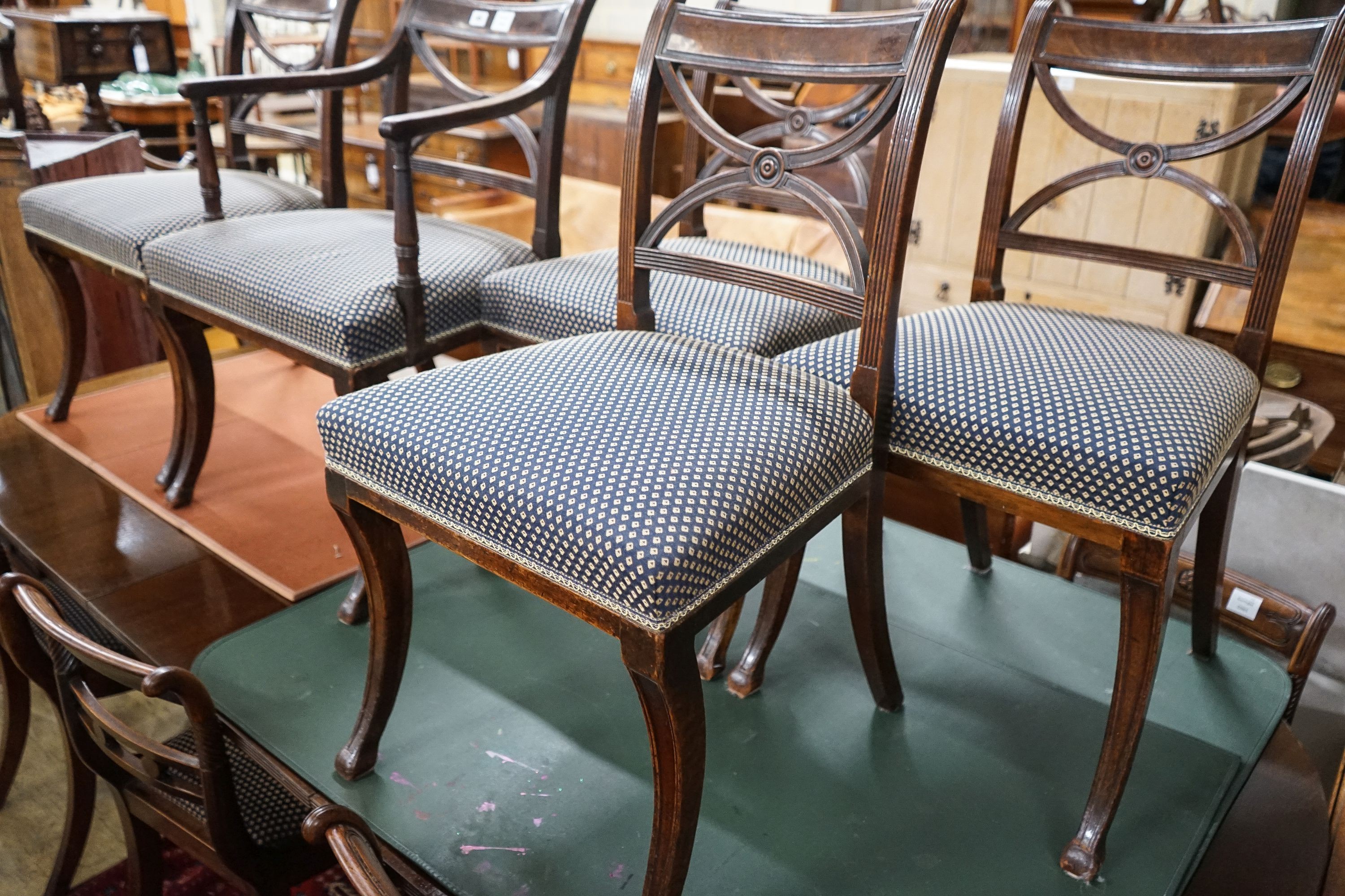 A set of five Regency mahogany dining chairs, (one with arms, four single)